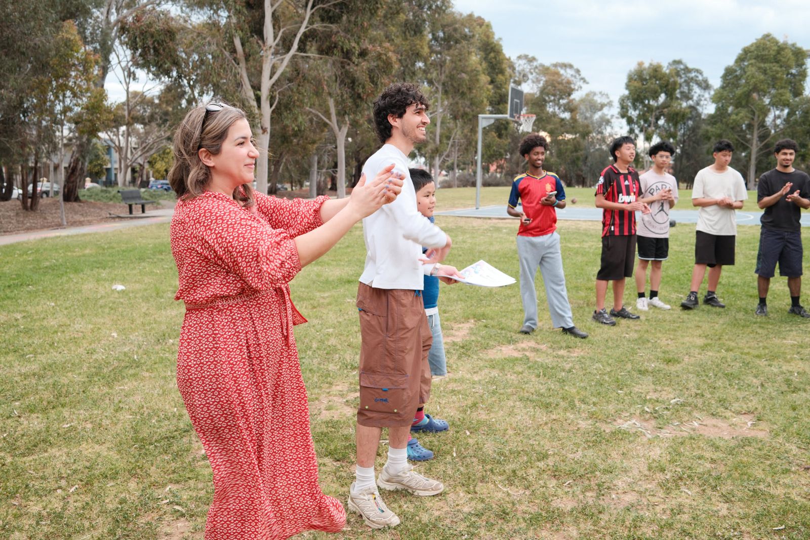 An animator leading a game on the grass