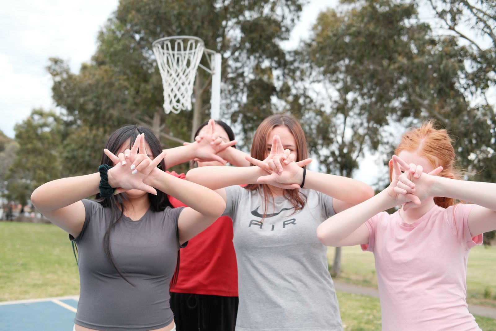 Junior youth striking a pose by the basketball court